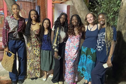 6 smiling students in traditional west african tissues and dress in Dakar, Senegal. 